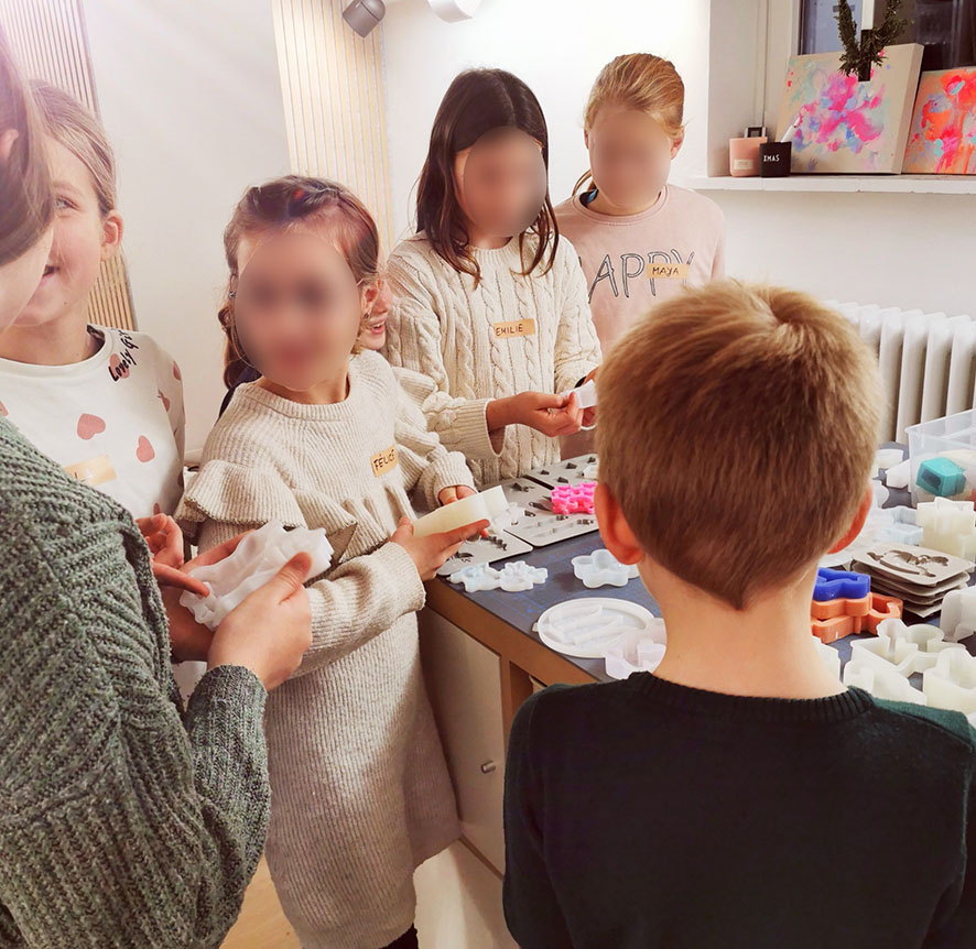 begeisterte Kinder beim kreativen Workshop im KreativWerk suchen sich Formen und Farben aus